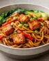 Bowl of sticky chili garlic tofu noodles with bok choy and peppers