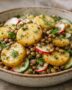 Bowl of warm potato salad with lentils, cucumber, radish, and herbs